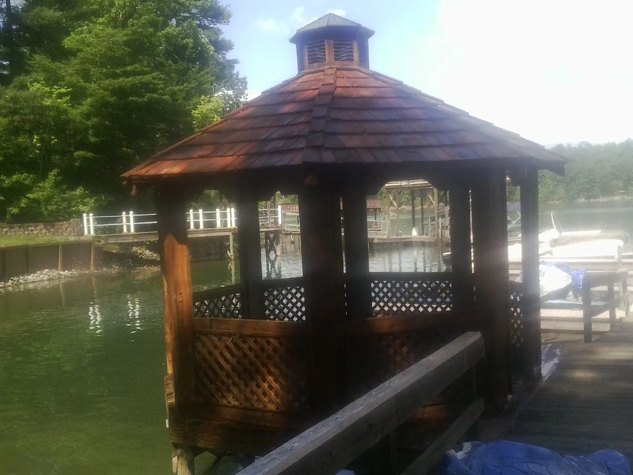 Cedar shake gazebo roof rebuilt on a lake dock in Braddyville